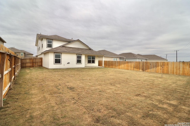 rear view of property featuring a yard