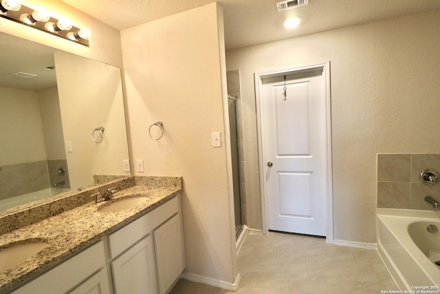 bathroom featuring tile patterned flooring and vanity