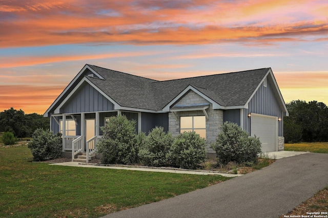 view of front of house with a yard and a garage