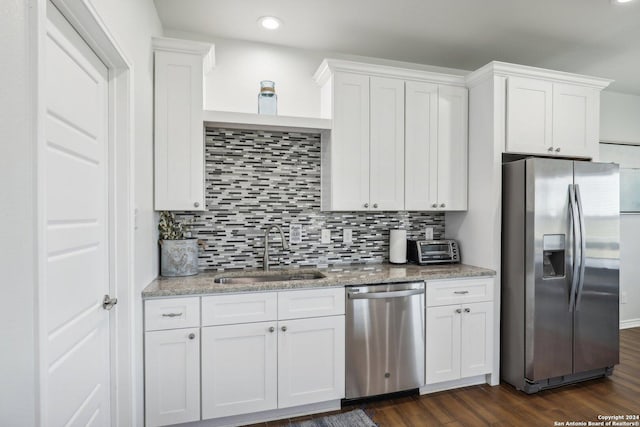 kitchen with sink, stainless steel appliances, white cabinetry, and dark wood-type flooring