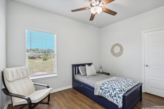 bedroom with ceiling fan and dark hardwood / wood-style floors