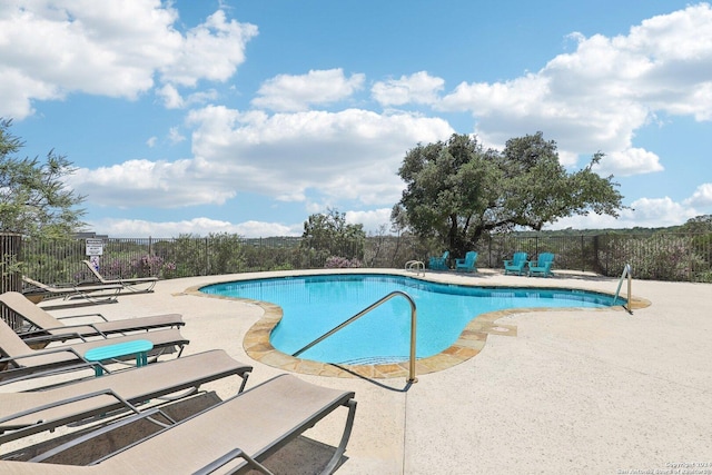 view of swimming pool with a patio