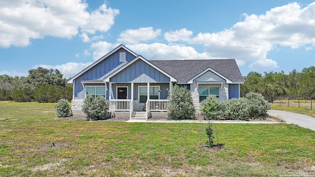 craftsman-style home with covered porch and a front yard