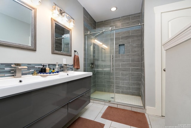 bathroom with vanity, tile patterned flooring, decorative backsplash, and a shower with shower door