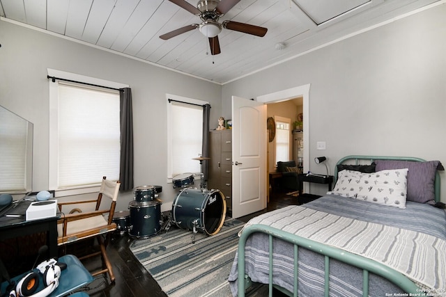 bedroom with ornamental molding, ceiling fan, and wood-type flooring