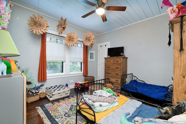 bedroom with ornamental molding, ceiling fan, and dark hardwood / wood-style floors