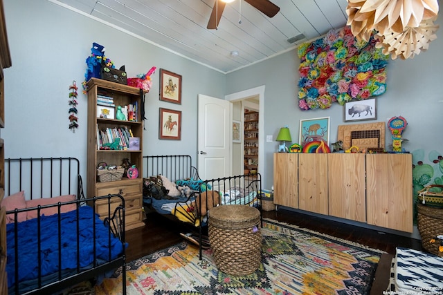 living area featuring ceiling fan, dark hardwood / wood-style flooring, ornamental molding, and wooden ceiling