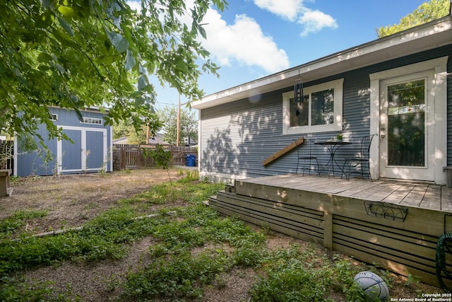 view of yard with a storage unit and a deck