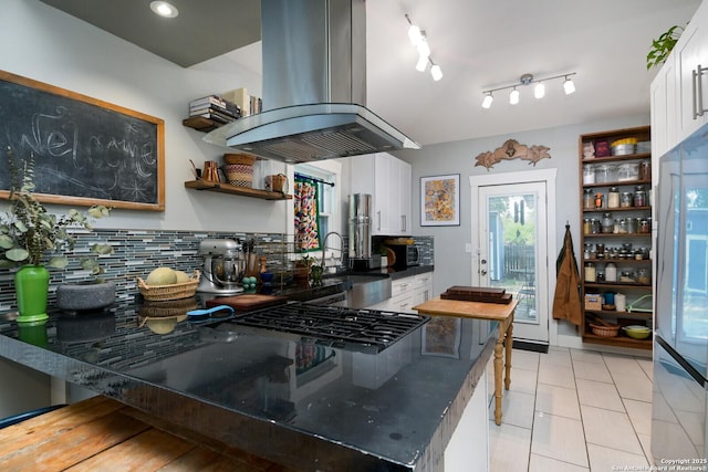 kitchen with sink, white cabinets, refrigerator, and island exhaust hood