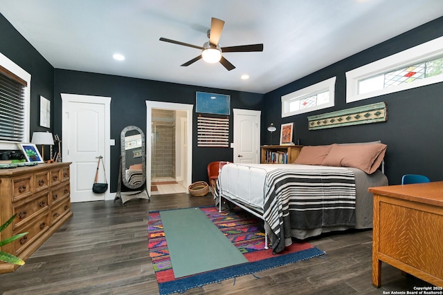 bedroom featuring ceiling fan, dark hardwood / wood-style flooring, and connected bathroom