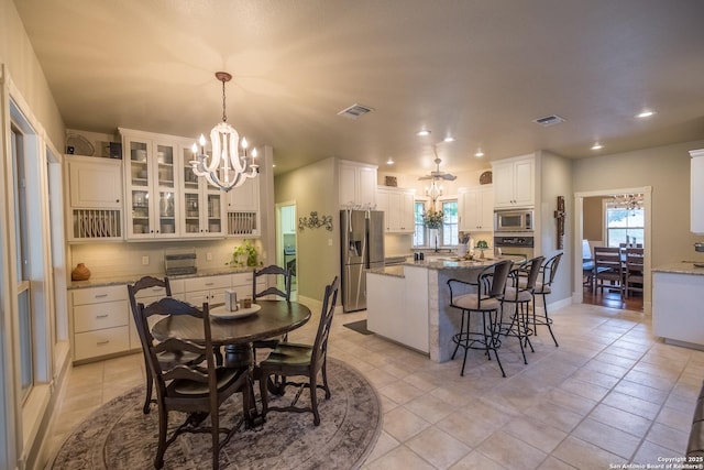 dining area featuring an inviting chandelier and light tile patterned floors