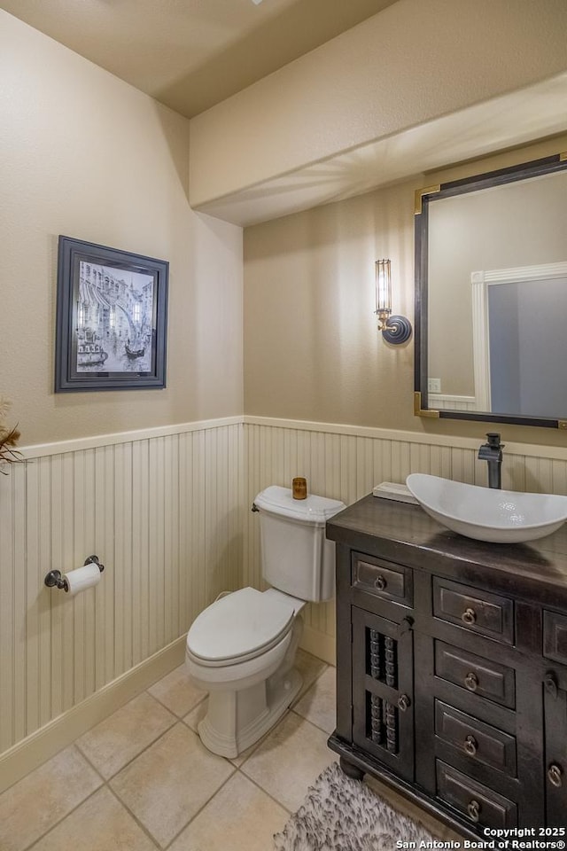 bathroom featuring vanity, tile patterned floors, and toilet