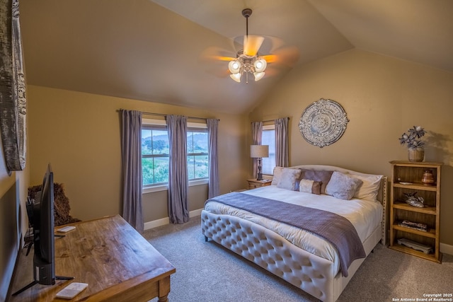 carpeted bedroom with ceiling fan and vaulted ceiling