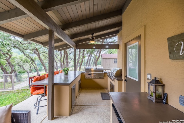 view of patio / terrace with ceiling fan, a grill, and area for grilling