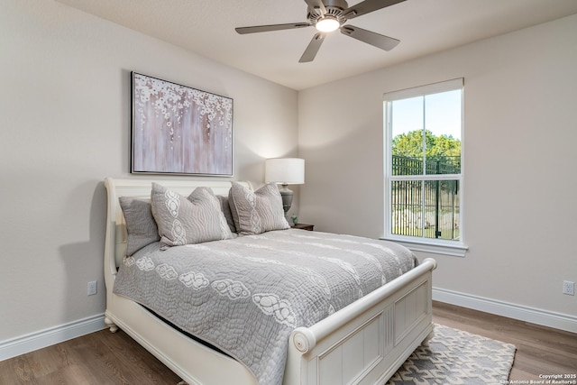 bedroom featuring ceiling fan and dark wood-type flooring