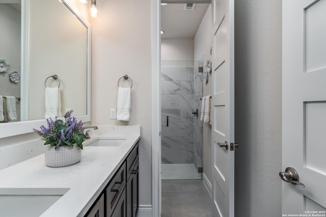 bathroom with a shower with door and vanity