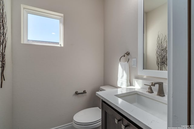 bathroom featuring toilet and vanity