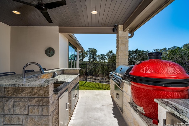 view of patio / terrace with an outdoor kitchen, grilling area, and ceiling fan