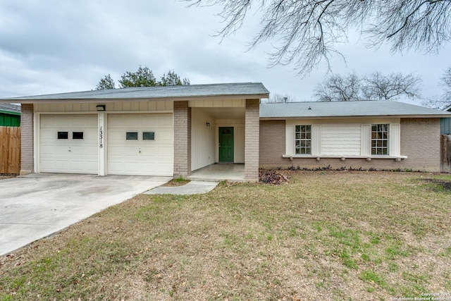 ranch-style home with a front lawn and a garage