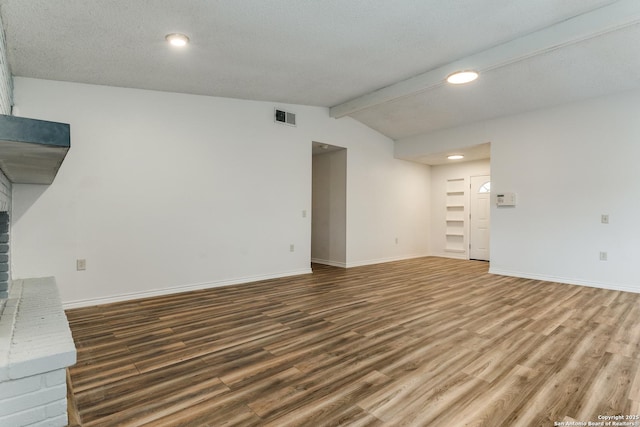 unfurnished living room with dark hardwood / wood-style floors and vaulted ceiling with beams