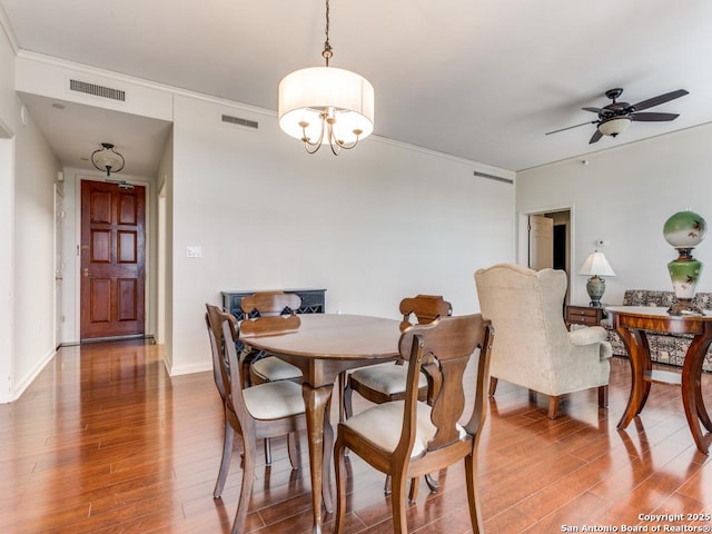 dining room with ceiling fan with notable chandelier and hardwood / wood-style floors