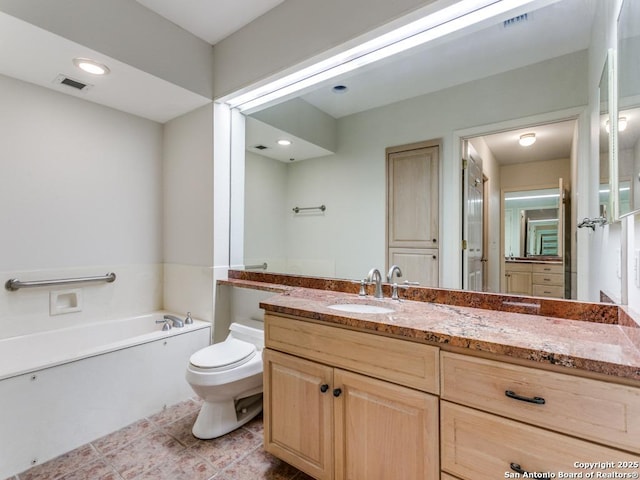 bathroom with toilet, tile patterned floors, a bathtub, and vanity