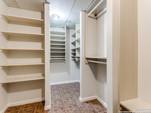 spacious closet with a drop ceiling