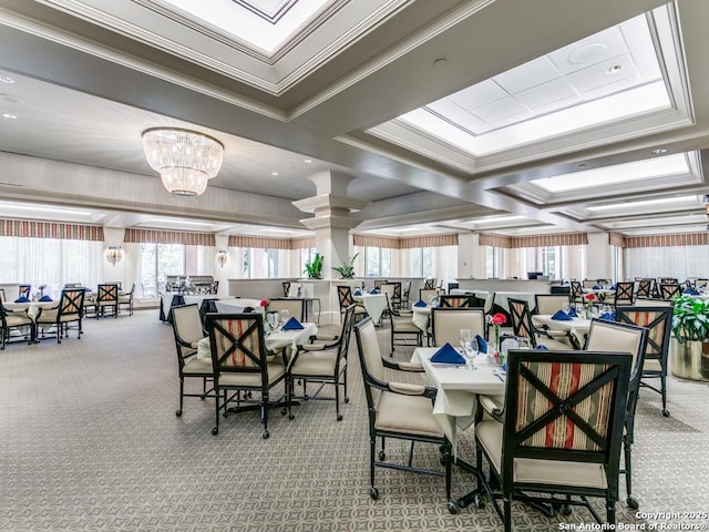 carpeted dining room with ornamental molding and a notable chandelier