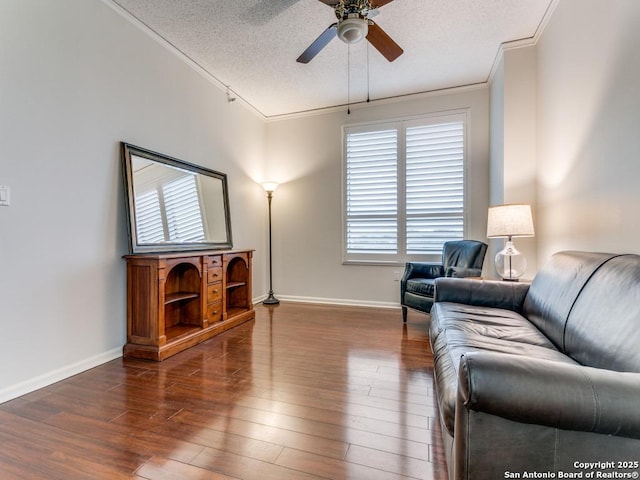 living room featuring a textured ceiling, ceiling fan, crown molding, and dark hardwood / wood-style floors