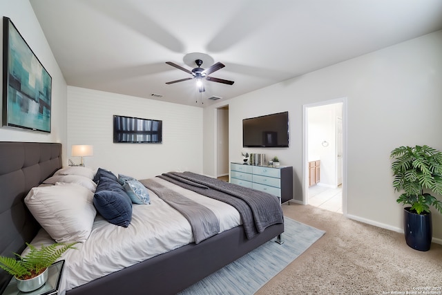 carpeted bedroom with ceiling fan and connected bathroom