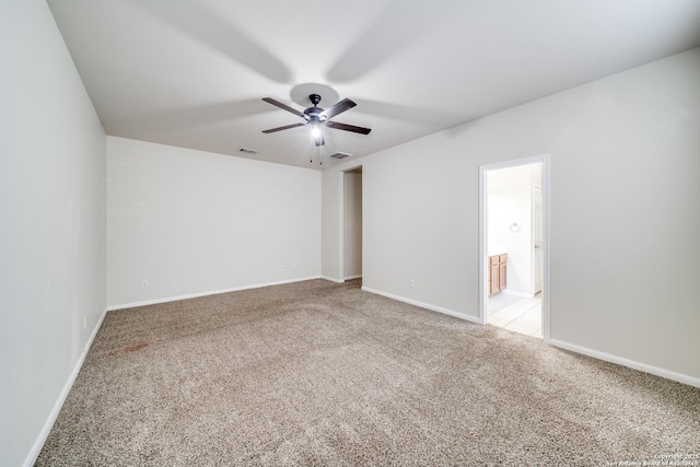 empty room with ceiling fan and light colored carpet