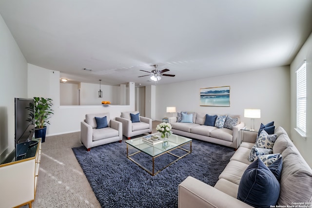 carpeted living room featuring ceiling fan