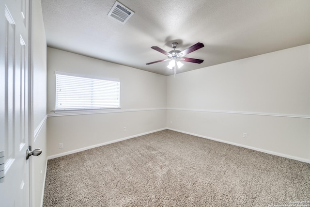 spare room with a textured ceiling, ceiling fan, and carpet flooring