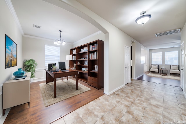 tiled home office featuring a notable chandelier and ornamental molding