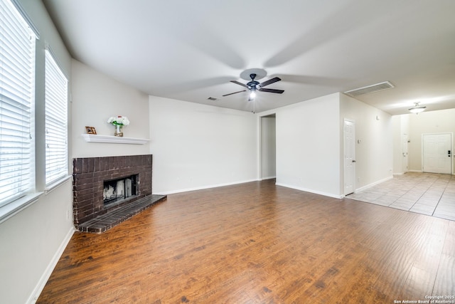 living room with hardwood / wood-style floors, a fireplace, and ceiling fan