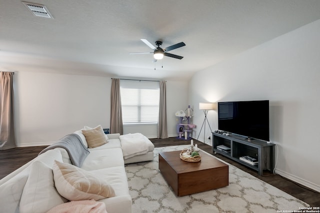 living room with wood-type flooring and ceiling fan