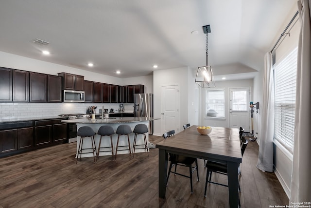 dining room featuring sink and dark wood-type flooring