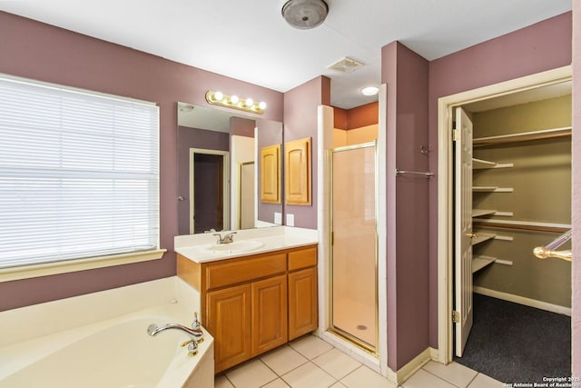 bathroom with vanity, tile patterned flooring, plenty of natural light, and plus walk in shower