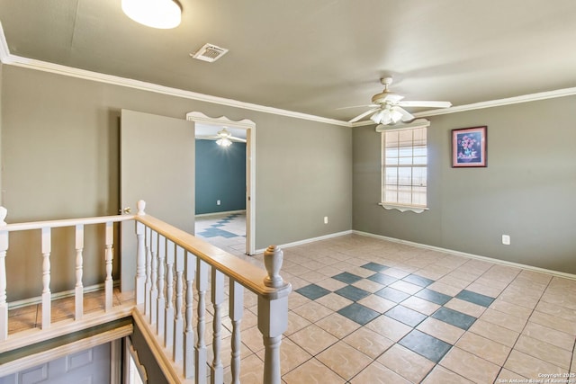 tiled spare room with ornamental molding and ceiling fan