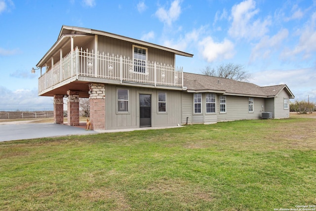 rear view of house with a lawn, central AC, and a patio area