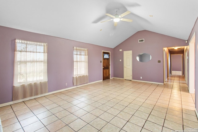 unfurnished living room with lofted ceiling, light tile patterned flooring, and ceiling fan