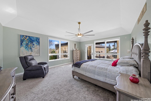 bedroom with a raised ceiling, ceiling fan, and carpet