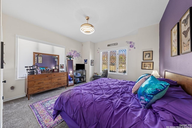 carpeted bedroom featuring multiple windows