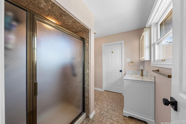 bathroom featuring an enclosed shower and vanity