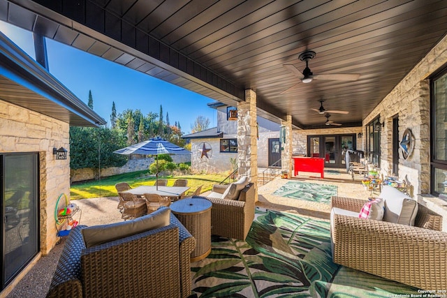 view of patio featuring ceiling fan and an outdoor living space