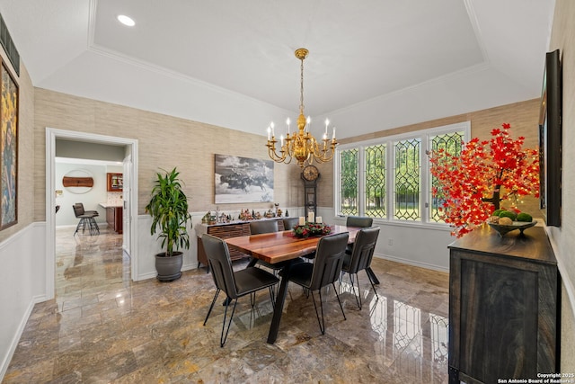 dining space with a raised ceiling, a chandelier, and ornamental molding