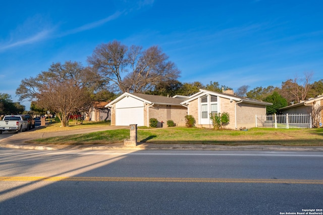 ranch-style house with a front yard and a garage