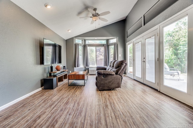 living room with lofted ceiling, light wood-type flooring, ceiling fan, and french doors