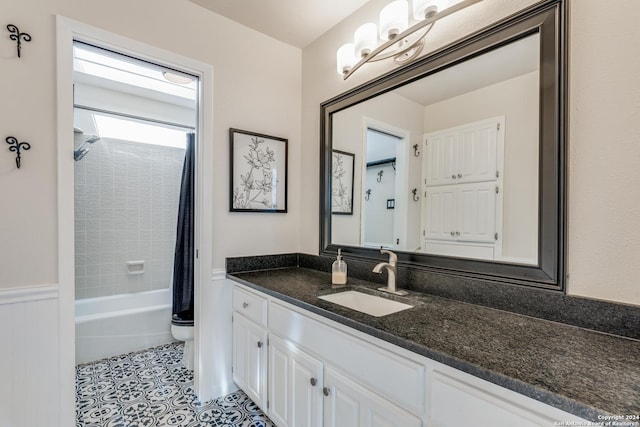 full bathroom featuring vanity, shower / bath combo with shower curtain, tile patterned floors, and toilet