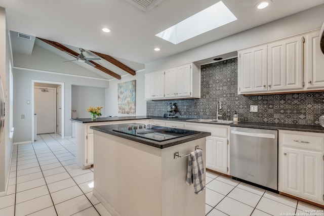 kitchen with dishwasher, white cabinets, a center island, and vaulted ceiling with skylight